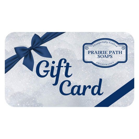 Prairie Path Soaps gift card with a blue bow on a white, lathery background